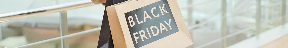 A person is holding a shopping bag with Black Friday written on it